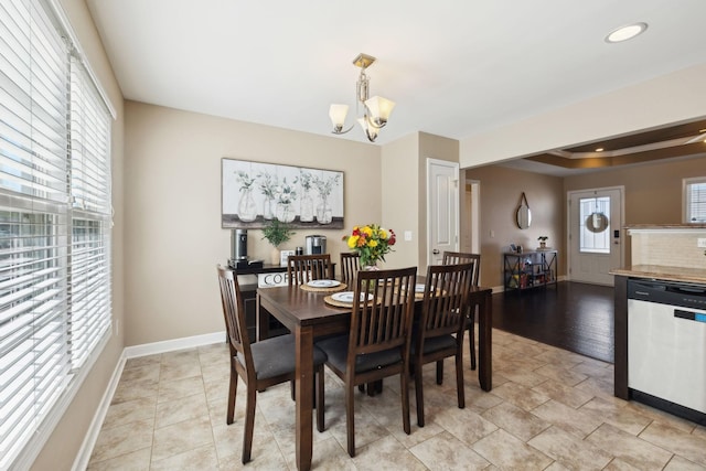 dining area with a chandelier, recessed lighting, a healthy amount of sunlight, and baseboards