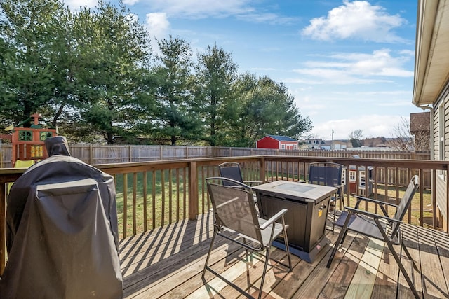 wooden terrace featuring a fenced backyard and grilling area