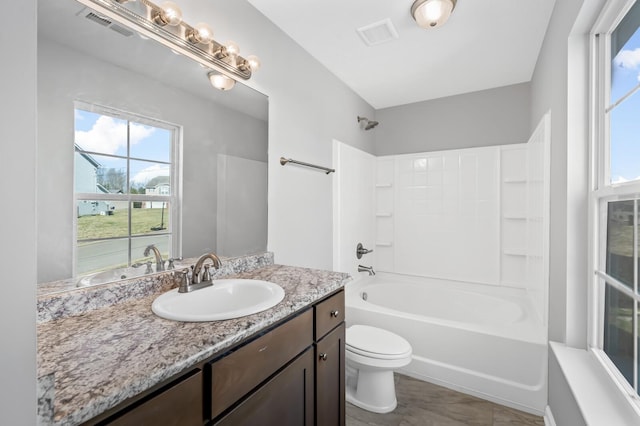 full bath featuring visible vents, vanity, toilet, and shower / bathing tub combination