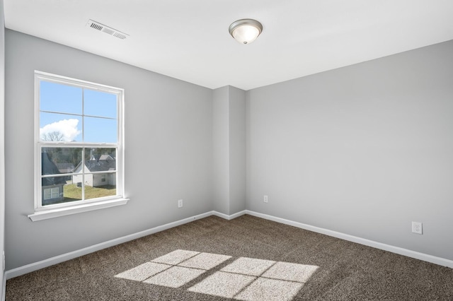 spare room with visible vents, carpet floors, and baseboards