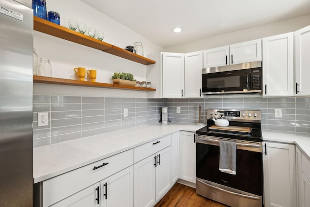 kitchen featuring open shelves, tasteful backsplash, stainless steel appliances, white cabinets, and light stone countertops