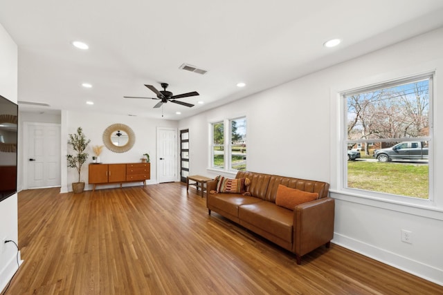 living area featuring light wood-type flooring, visible vents, and recessed lighting