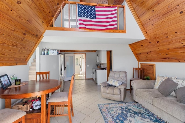 dining room featuring light tile patterned floors, stairway, wood ceiling, and vaulted ceiling