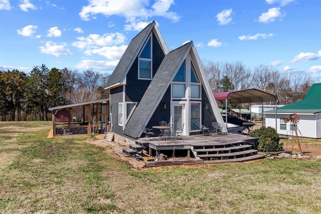 back of house featuring a detached carport, a deck, a shingled roof, and a yard