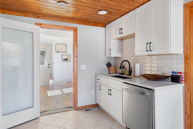 kitchen featuring visible vents, light tile patterned floors, decorative backsplash, stainless steel dishwasher, and a sink