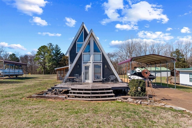 rear view of property featuring a detached carport, a yard, driveway, and a wooden deck