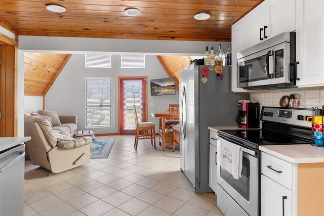 kitchen featuring backsplash, wood ceiling, light countertops, light tile patterned flooring, and stainless steel appliances