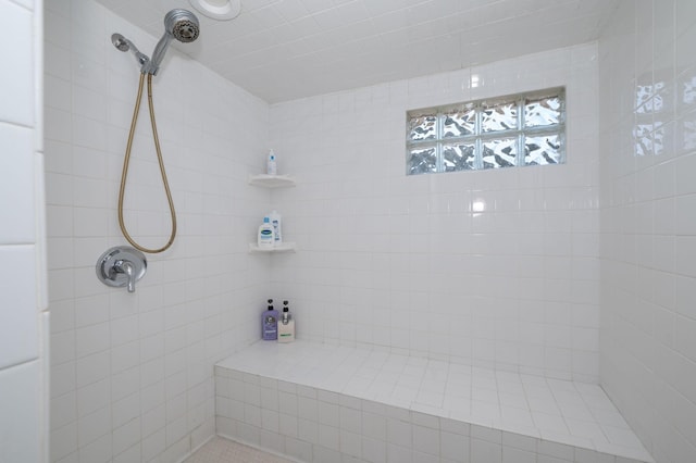 bathroom featuring a tile shower