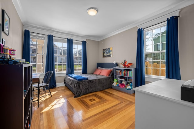 bedroom with light wood-type flooring and crown molding