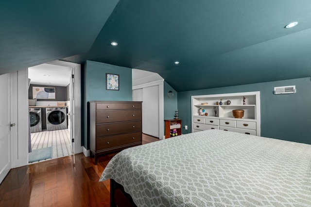 bedroom featuring vaulted ceiling, dark wood-style floors, recessed lighting, and separate washer and dryer