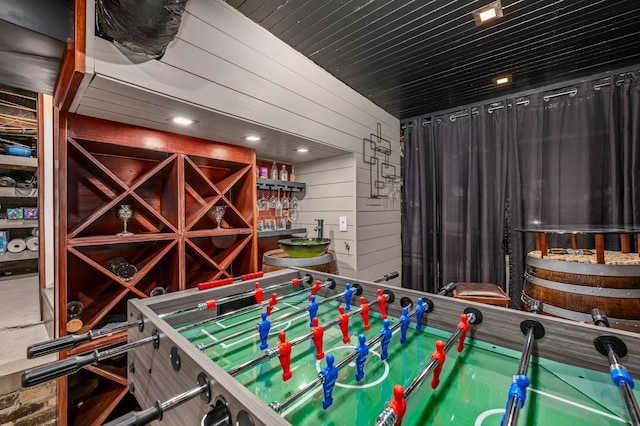 recreation room featuring wooden walls