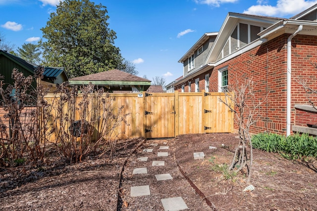 view of yard featuring fence and a gate