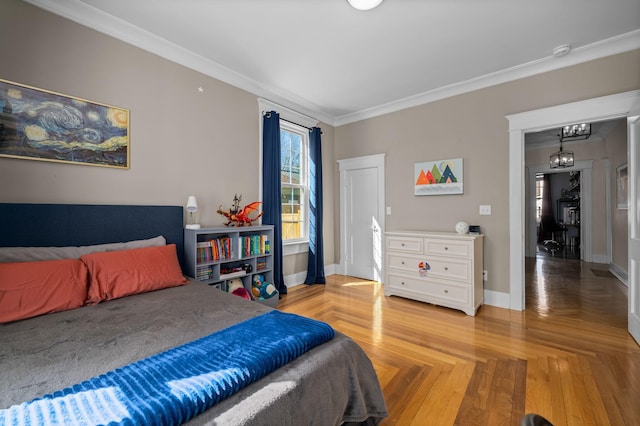 bedroom with a notable chandelier, baseboards, and ornamental molding