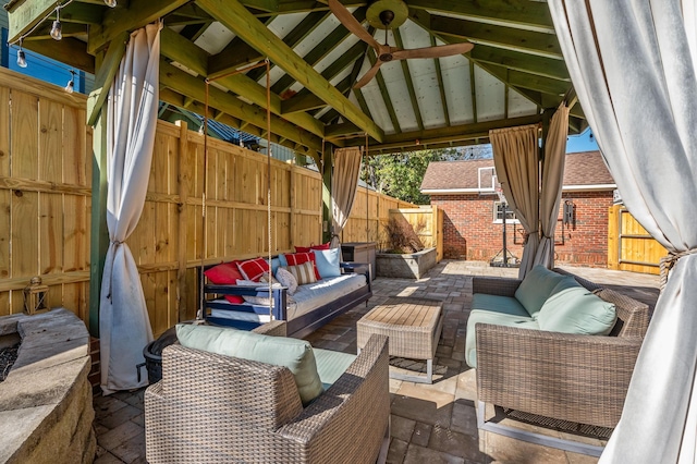 view of patio with a gazebo, outdoor lounge area, and fence