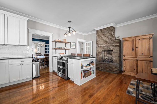 kitchen featuring dark countertops, double oven range, a fireplace, and open shelves