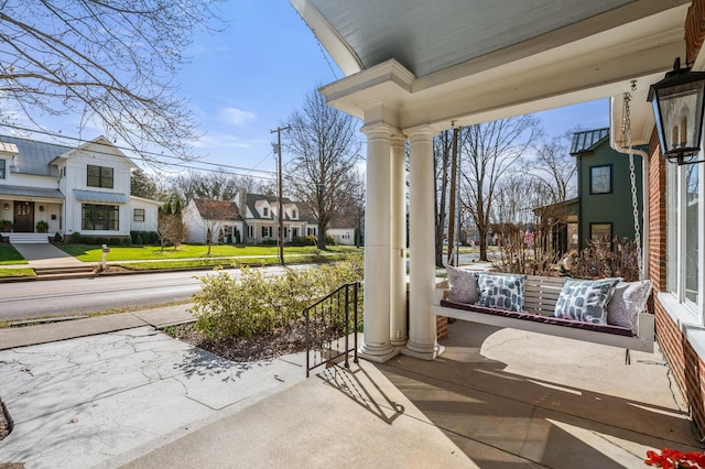 view of patio / terrace with a residential view and a porch