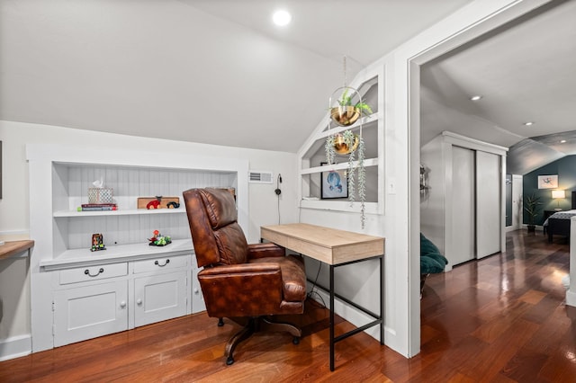 home office with built in features, visible vents, and wood finished floors