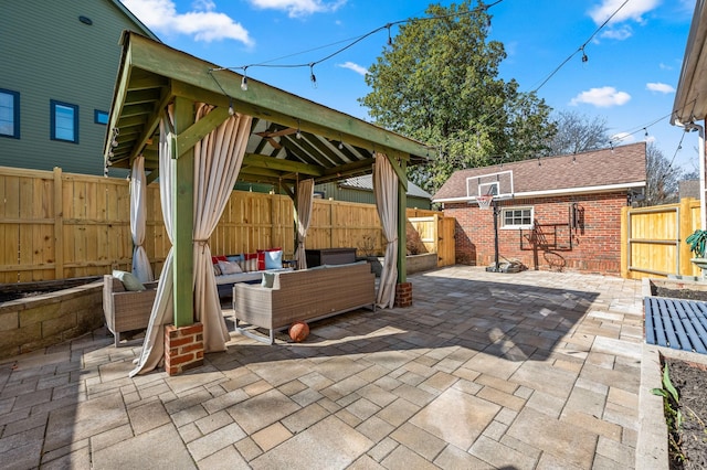 view of patio featuring a gazebo, a fenced backyard, and outdoor lounge area