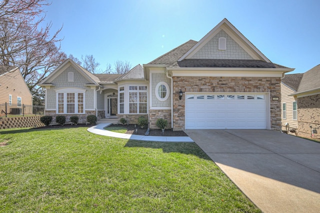 craftsman house with a front lawn, fence, concrete driveway, a shingled roof, and a garage