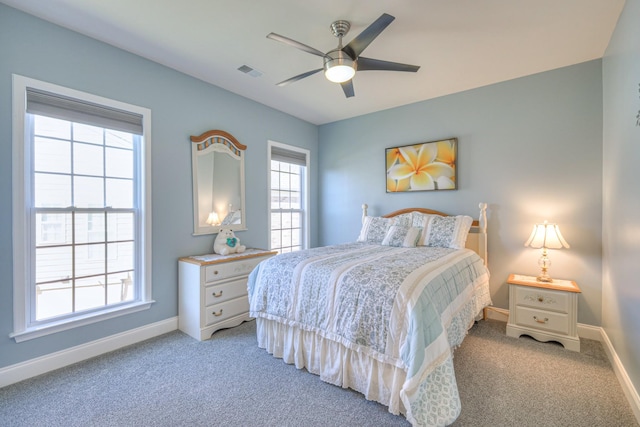 bedroom with light carpet, visible vents, and baseboards