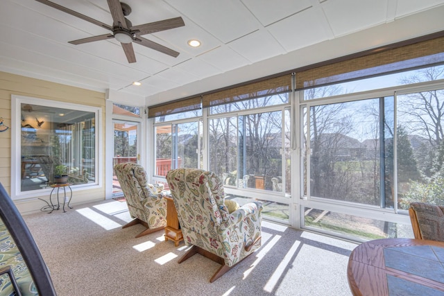 sunroom / solarium with a ceiling fan