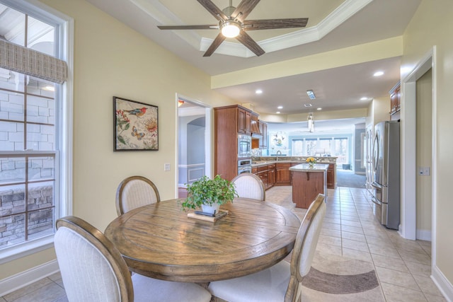 dining space featuring a ceiling fan, recessed lighting, arched walkways, light tile patterned floors, and baseboards