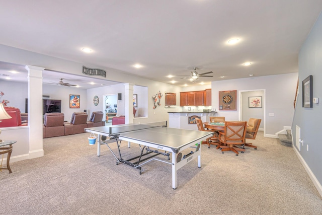 recreation room featuring ceiling fan, ornate columns, and light carpet