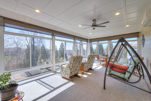 sunroom / solarium with a wall mounted air conditioner and ceiling fan