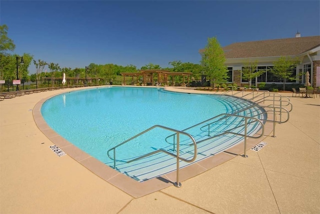 community pool with a patio area