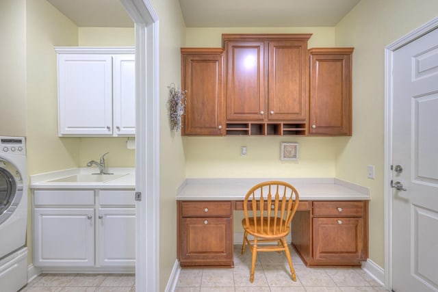 home office with a sink, baseboards, washer / clothes dryer, and built in study area