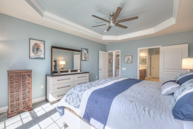 bedroom featuring a raised ceiling, light carpet, baseboards, and ornamental molding