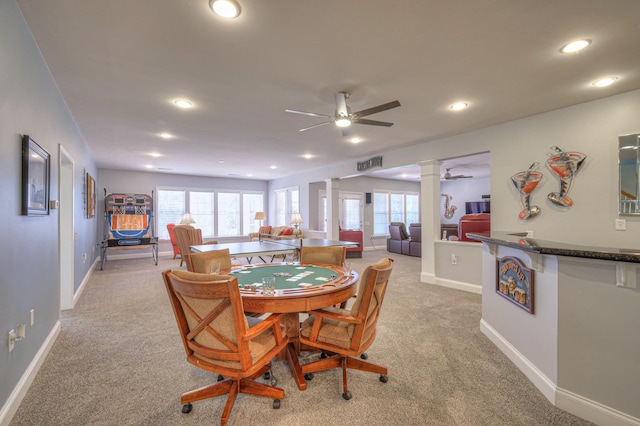 dining room with recessed lighting, light carpet, a healthy amount of sunlight, and ornate columns