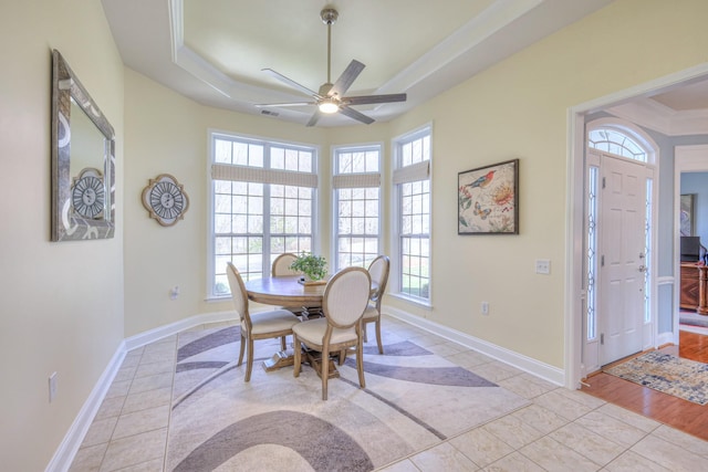 dining space with visible vents, a raised ceiling, a ceiling fan, light tile patterned flooring, and baseboards