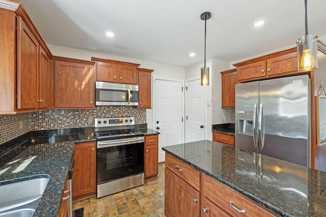 kitchen with decorative backsplash, brown cabinets, and appliances with stainless steel finishes