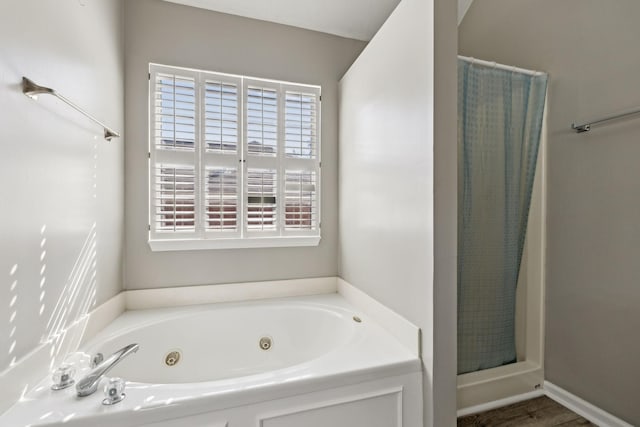 full bathroom featuring a shower with shower curtain and a whirlpool tub