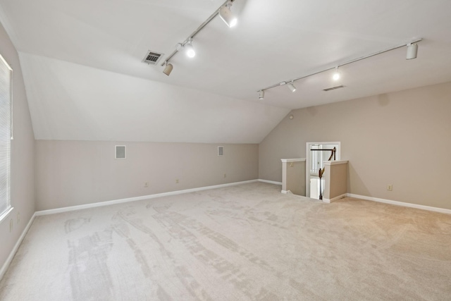 additional living space featuring lofted ceiling, carpet, visible vents, and baseboards