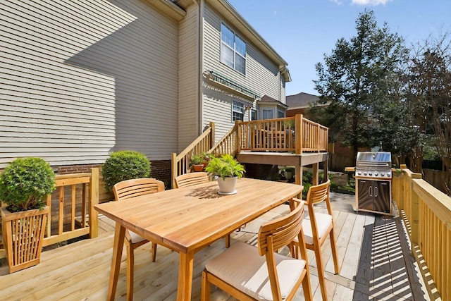 wooden deck featuring outdoor dining area and grilling area