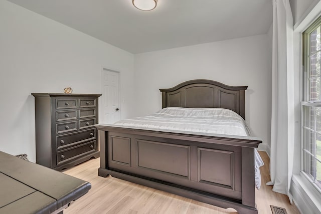 bedroom with visible vents and light wood-type flooring