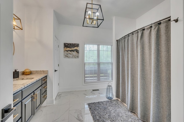 full bathroom featuring vanity, curtained shower, baseboards, and marble finish floor