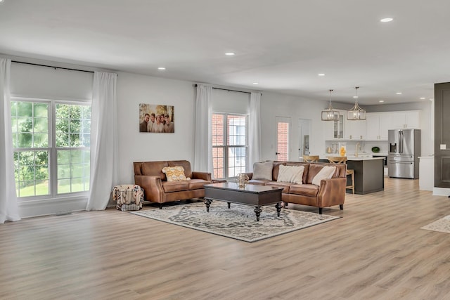 living room featuring light wood-style flooring and recessed lighting