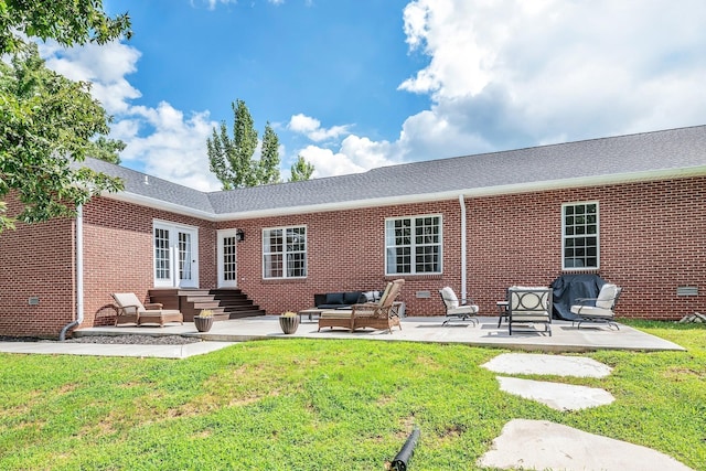 rear view of property with brick siding, a lawn, outdoor lounge area, and a patio