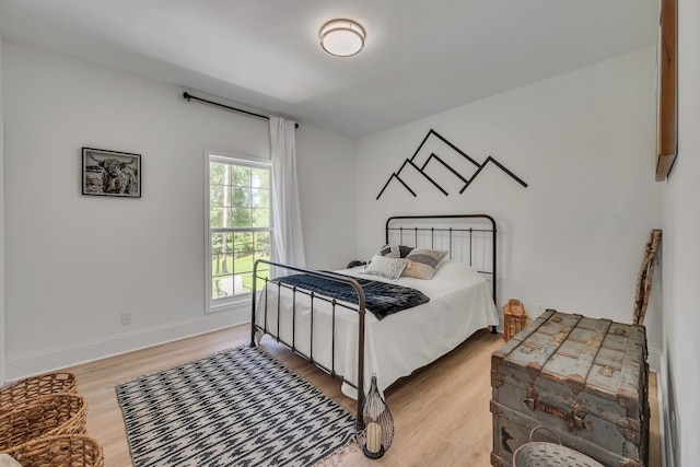 bedroom with baseboards and light wood-style floors