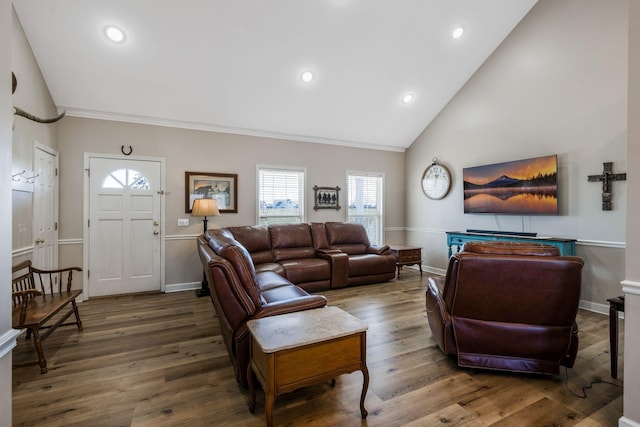 living area featuring recessed lighting, wood finished floors, baseboards, and high vaulted ceiling