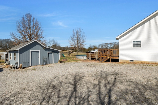 view of yard featuring a deck and an outdoor structure