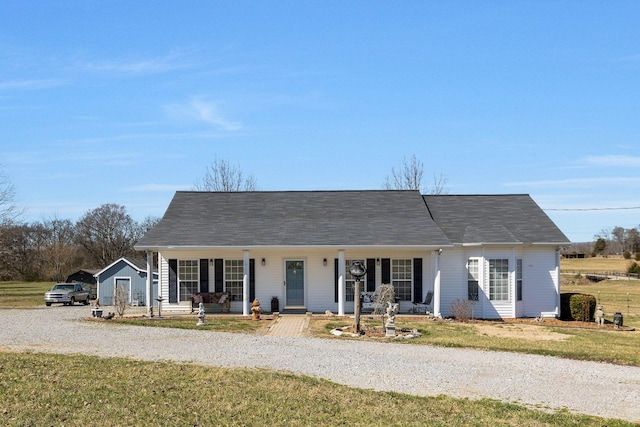 view of front of home with a front yard, a porch, and driveway