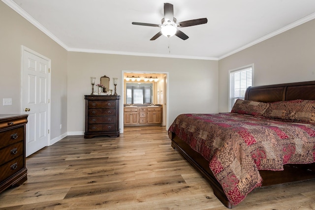 bedroom with crown molding, light wood-style floors, baseboards, and connected bathroom