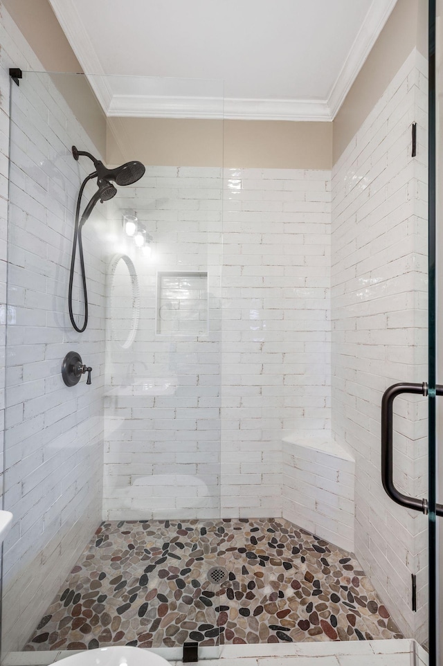 bathroom with a shower stall and ornamental molding