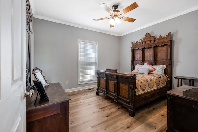 bedroom with visible vents, crown molding, baseboards, light wood-style floors, and a ceiling fan