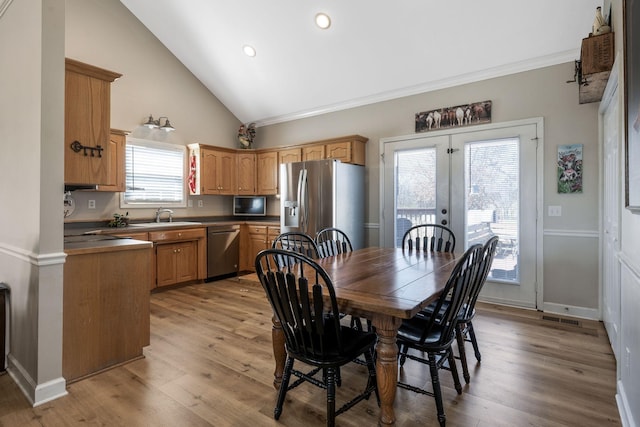 dining area featuring french doors, visible vents, light wood finished floors, and baseboards