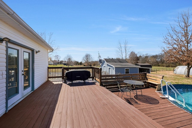 deck with an outbuilding and a storage unit